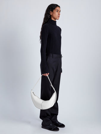 Image of model holding Slide Bag in Smooth Nappa in WHITE