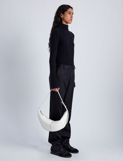 Image of model holding Slide Bag in Smooth Nappa in WHITE